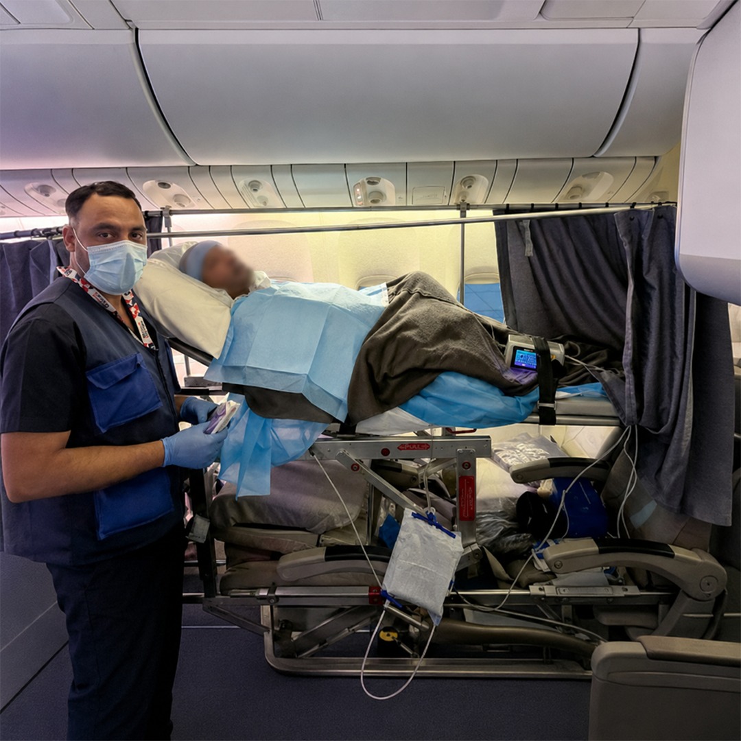 Patient being transferred on airline stretcher with medical escort
